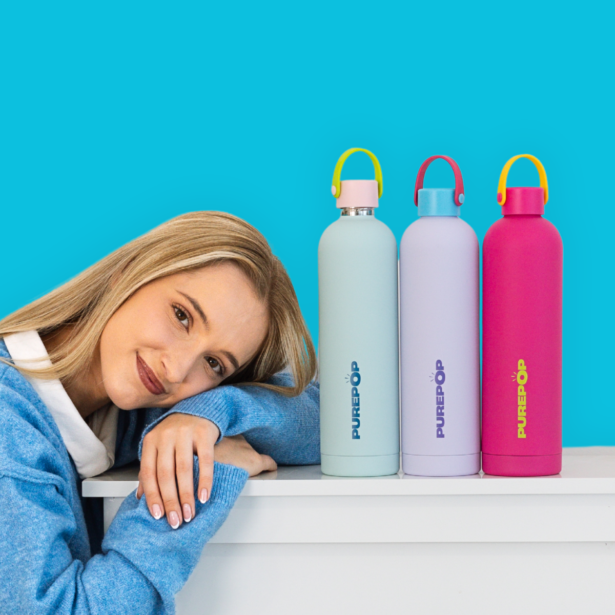 Bright yellow insulated water bottle with a black screw-on lid and a carrying handle, standing upright on a white background. PUREPOP logo is printed vertically on the bottle.