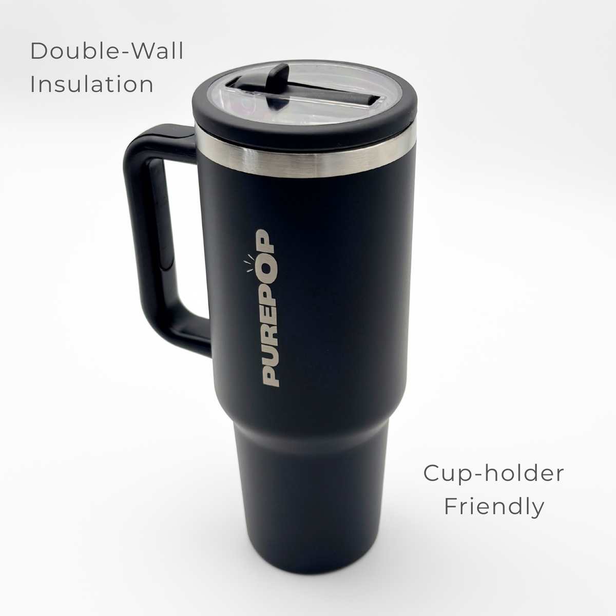 The Carry Series | Onyx Black by PurePop™ is a black travel mug with a clear lid and handle. Image text highlights Double-Wall Insulation for lasting temperature control and a cup-holder friendly design for convenience.