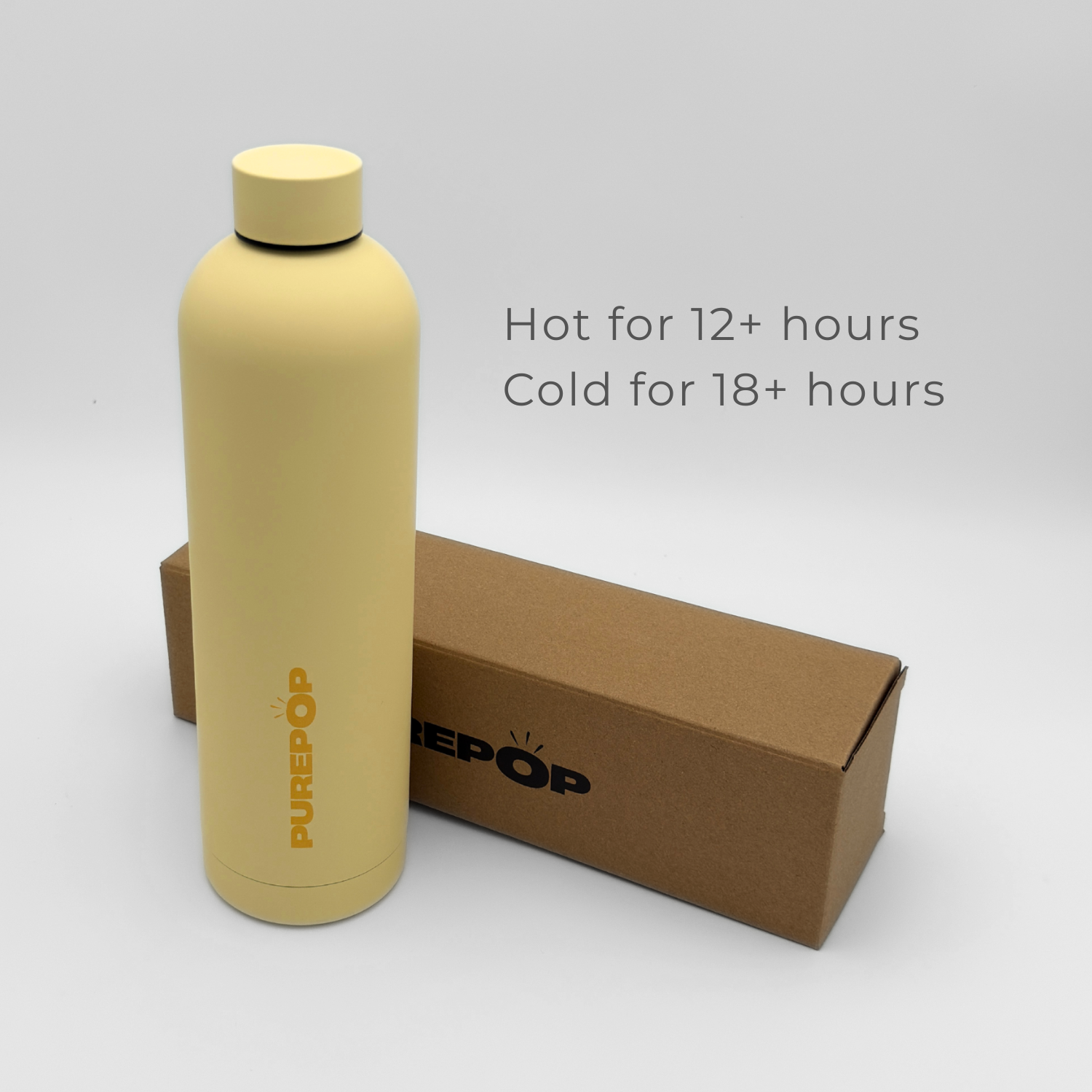 A Core Series Plus | Canary Yellow PUREPOP insulated flask stands next to a brown box. Text reads: Hot for 12+ hours, Cold for 18+ hours. Made from durable stainless steel and completely leakproof, it sits against a plain, light-colored background.