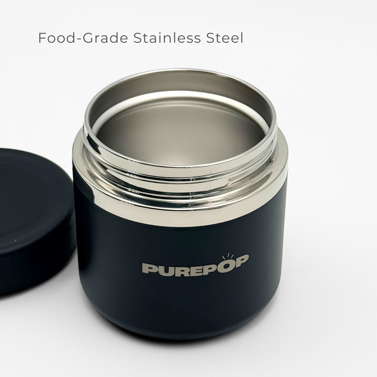 A spacious Purepop Food Flask | Onyx Black is displayed with the lid off, showcasing its empty food-grade stainless steel interior against a white background.