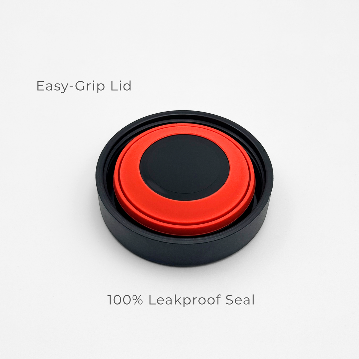 A circular red and black lid from the Purepop Food Flask | Onyx Black is displayed on a white background. "Easy-Grip Lid" appears above and "100% Leakproof Seal" below, emphasizing its secure, user-friendly design.