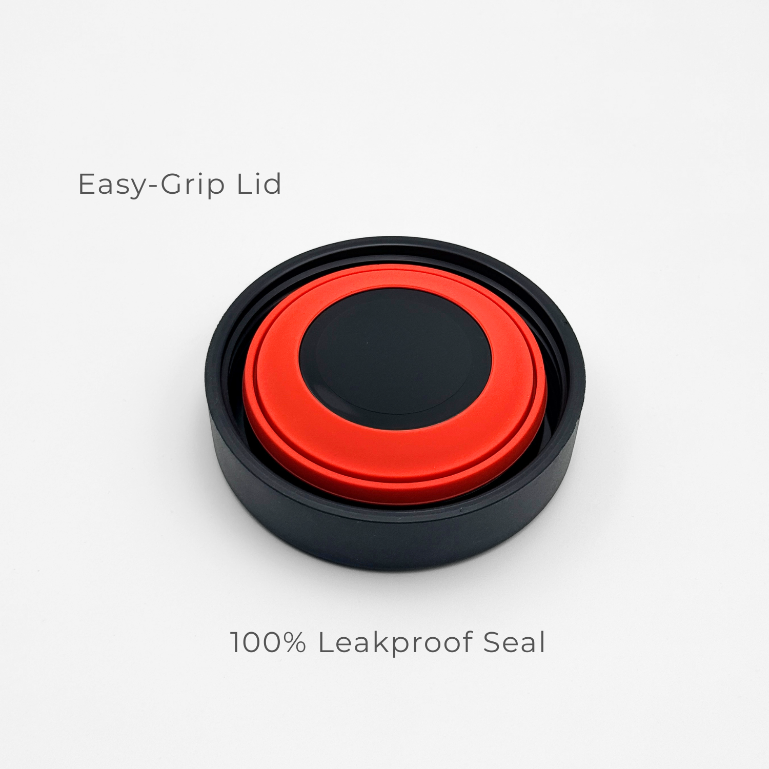 A circular red and black lid from the Purepop Food Flask | Onyx Black is displayed on a white background. "Easy-Grip Lid" appears above and "100% Leakproof Seal" below, emphasizing its secure, user-friendly design.