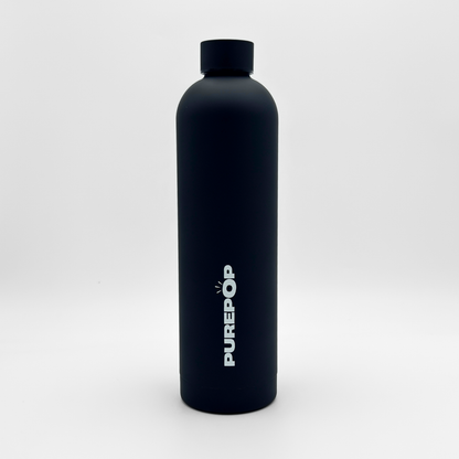 A Core Series Plus | Onyx Black water bottle stands upright on a white background. Crafted from double-walled stainless steel, this insulated flask features a sleek black cap and the word PUREPOP printed vertically in white letters on its side.
