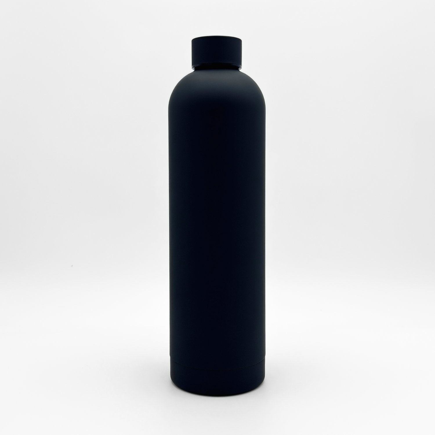 The Core Series Plus | Onyx Black is a matte black, cylindrical double-walled stainless steel water bottle with a screw-on lid, shown standing upright against a plain white background.
