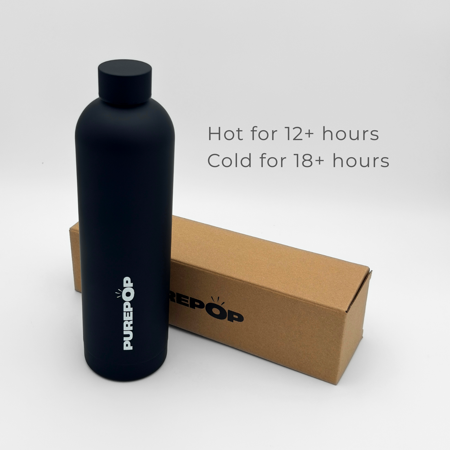 A Core Series Plus | Onyx Black PUREPOP insulated flask with a leakproof lid stands next to its brown box. Text reads: Hot for 12+ hours, Cold for 18+ hours. The double-walled stainless steel bottle is set against a plain white background.