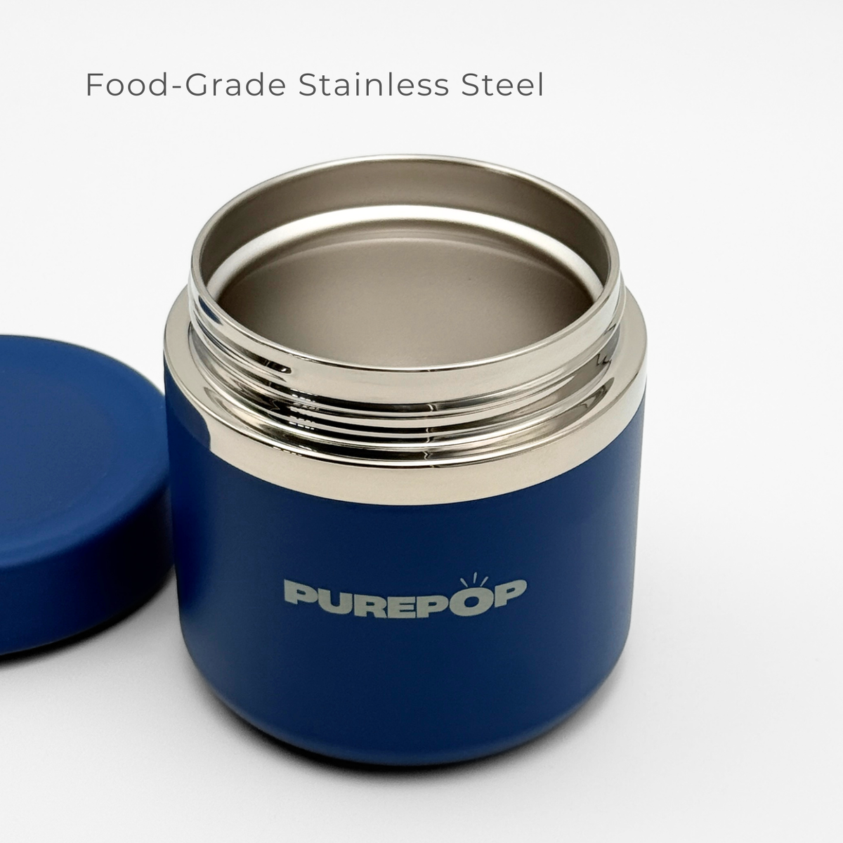 A Royal Blue Food Flask by Purepop is shown with its lid off, displaying the interior. "Food-Grade Stainless Steel" appears above, and Purepop is printed on the front of this durable container.