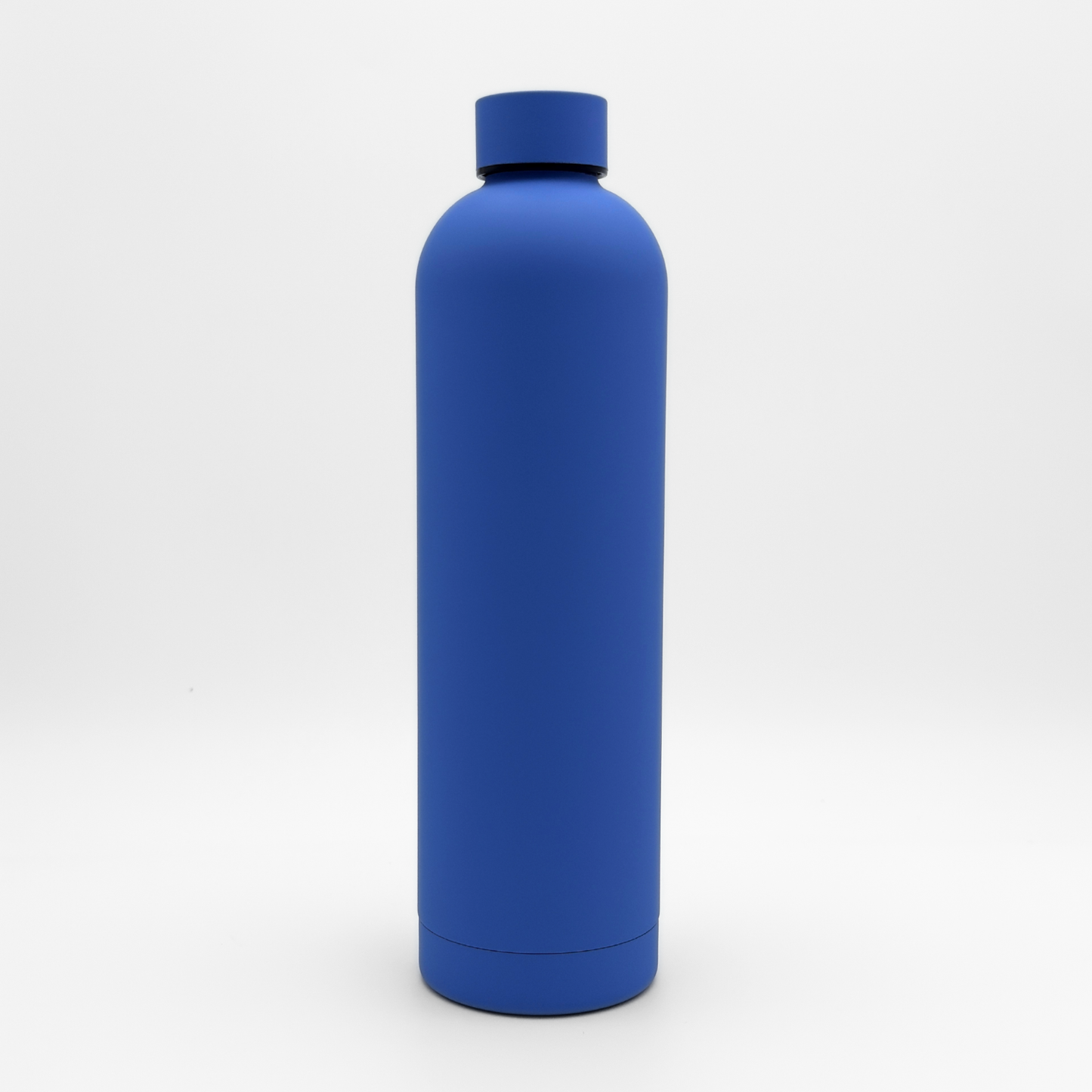 The Core Series Plus | Ultra Marine, a matte blue stainless steel thermal bottle with a matching cap, stands upright against a white background.