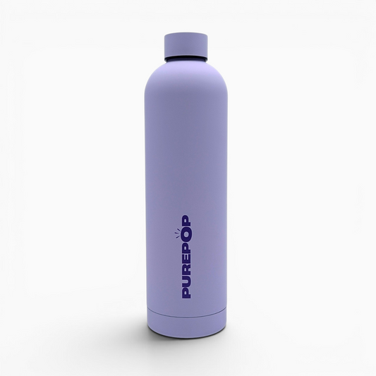 A matte pastel lilac insulated flask from the Core Series Plus stands upright on a white background, featuring the brand name PURE POP in bold, capital letters printed vertically on the front. This double-walled stainless steel water bottle is designed to keep your drinks at the perfect temperature while ensuring a leakproof experience.