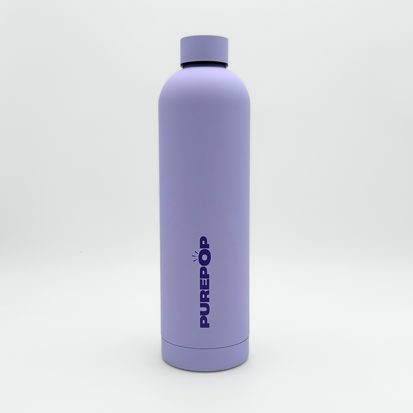 A tall, matte pastel lilac leakproof water bottle from the Core Series Plus collection stands upright on a white background. The double-walled stainless steel bottle features a matching lilac cap and has "PUREPOP" printed vertically in bold blue letters on the front.