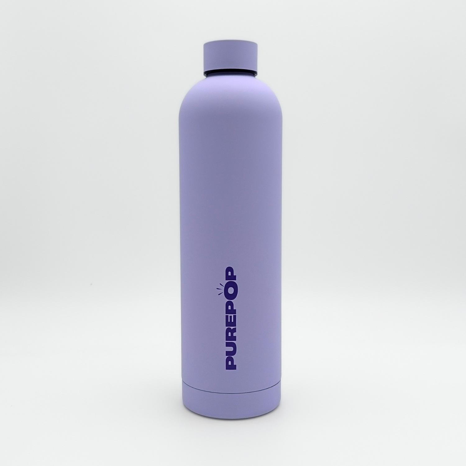 A tall, matte pastel lilac leakproof water bottle from the Core Series Plus collection stands upright on a white background. The double-walled stainless steel bottle features a matching lilac cap and has "PUREPOP" printed vertically in bold blue letters on the front.