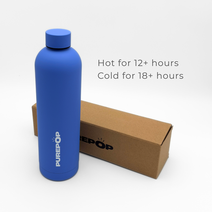 An Ultra Marine Core Series Plus PUREPOP stainless steel thermal bottle stands next to a brown box. Text beside the bottle reads: Hot for 12+ hours. Cold for 18+ hours.
