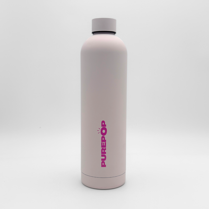 A tall Core Series Plus | Cloud Pink water bottle stands upright on a plain white background, featuring the PUREPOP brand name in bold pink letters. Crafted from double-walled stainless steel for superior insulation, this flask keeps drinks hot or cold for hours and boasts a leakproof design for worry-free carrying.