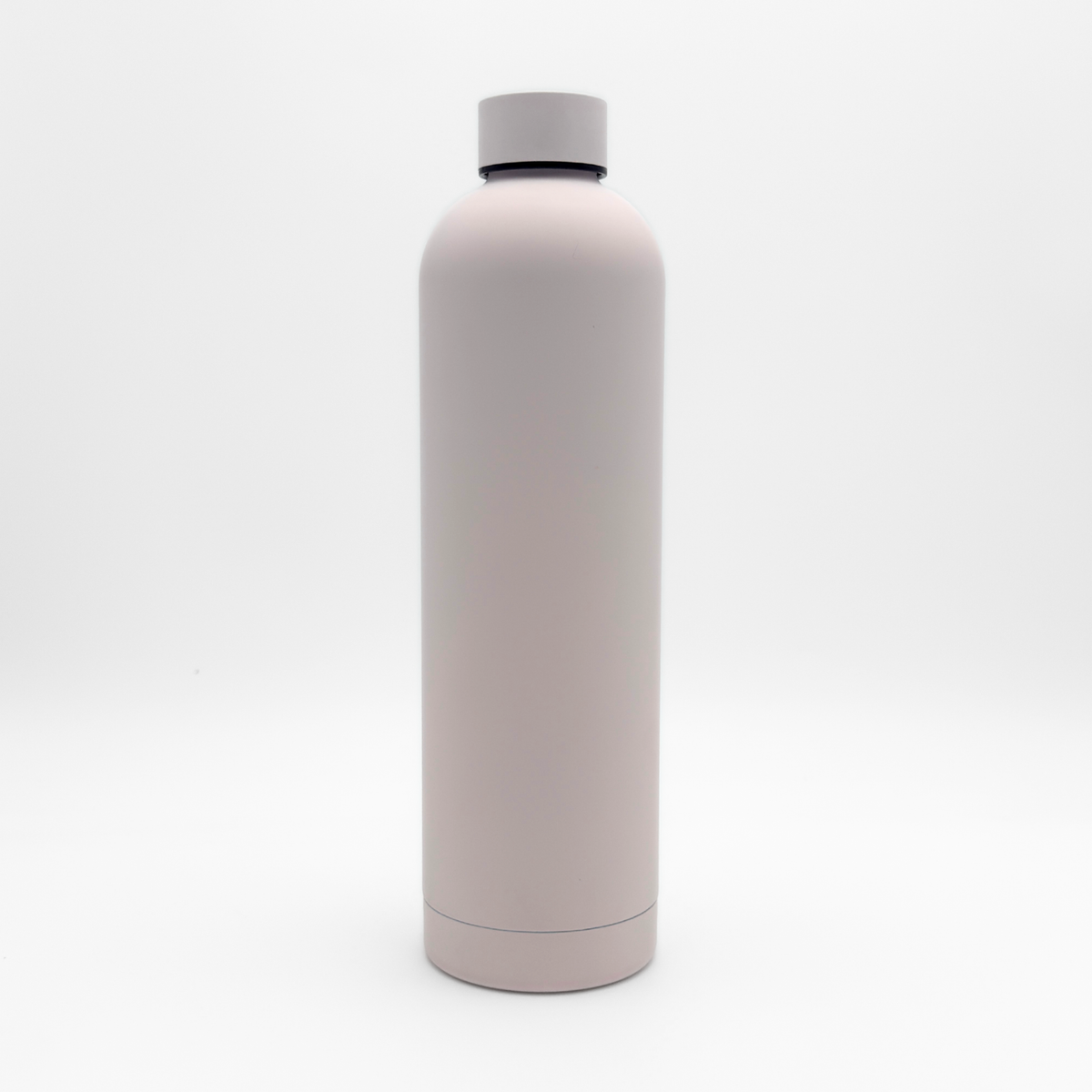 Core Series Plus | Cloud Pink reusable insulated flask, featuring a minimalist light pink design and a screw-on lid, standing upright against a plain white background.