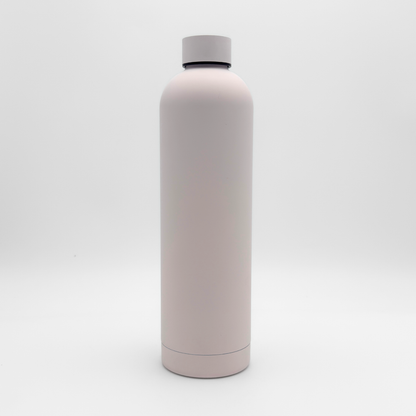Standing upright on a plain white background is the Core Series Plus | Cloud Pink—a tall, cylindrical, light pink insulated flask with a matching screw-on lid. This double-walled stainless steel water bottle is designed to be completely leakproof for everyday use.