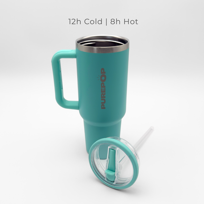 A PurePop™ Carry Series | Eucalyptus travel mug with handle and clear lid stands upright with a straw in front. Text above reads: 12h Cold | 8h Hot. The background is plain white.