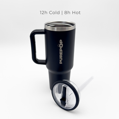 A Carry Series | Onyx Black travel mug by PurePop™ stands upright with its clear straw lid in front. Above, text reads: 12h Cold | 8h Hot. The background is white.