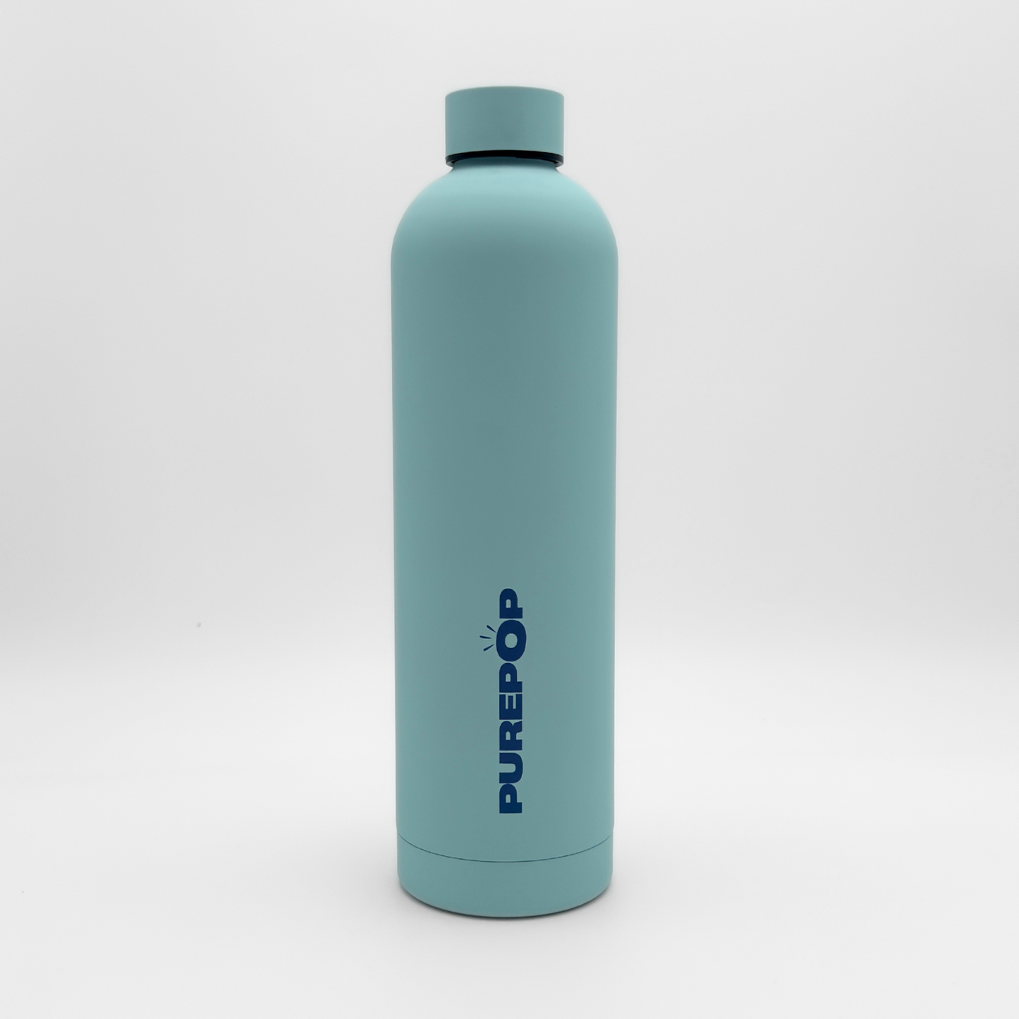 A Core Series Plus | Ice Blue reusable water bottle stands upright on a white background with PUREPOP written vertically in bold dark blue letters on the front. This insulated flask features double-walled stainless steel construction, ensuring your drinks stay at the perfect temperature while remaining completely leakproof.