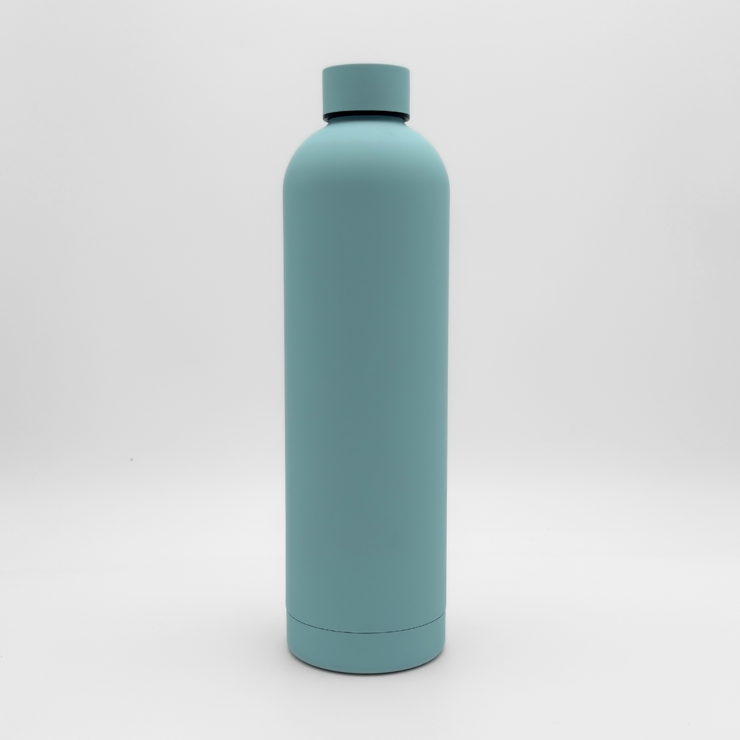 The Core Series Plus | Ice Blue, a matte light blue insulated flask with a screw-on lid, is standing upright against a white background.