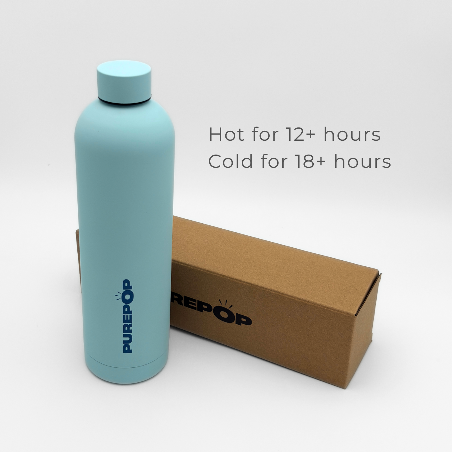 An Ice Blue Core Series Plus double-walled stainless steel insulated flask stands next to a brown box. Text beside the bottle reads, Hot for 12+ hours, Cold for 18+ hours.
