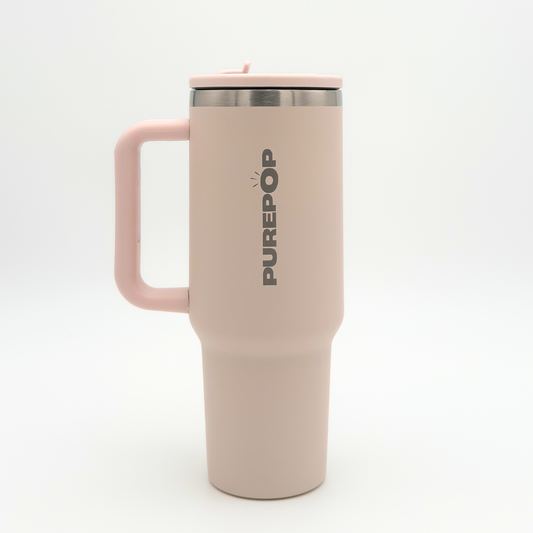 A tall, light pink PurePop™ Carry Series | Rose Quartz travel mug with a handle and silver lid stands against a plain white background.