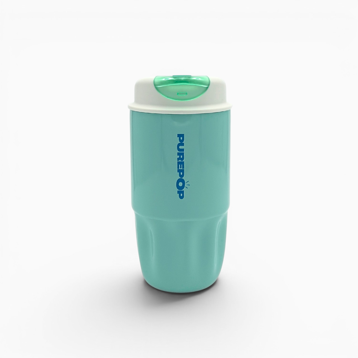 A Soft Aqua Sip Series travel mug stands upright on a white background, featuring a turquoise body, a white lid with a green button, and bold blue PUREPOP branding. This leakproof mug is perfect for enjoying your favorite beverages on the go.
