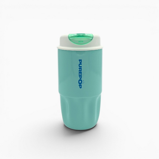 A Soft Aqua Sip Series travel mug stands upright on a white background, featuring a turquoise body, a white lid with a green button, and bold blue PUREPOP branding. This leakproof mug is perfect for enjoying your favorite beverages on the go.