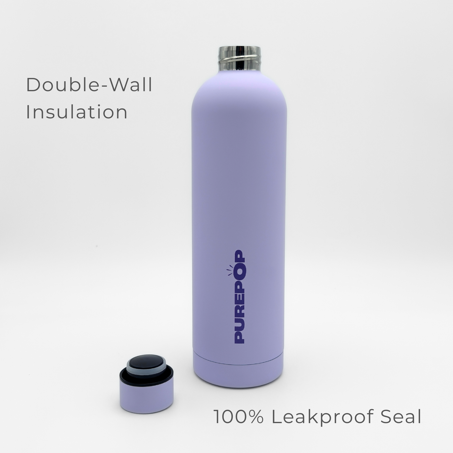A Core Series Plus | Pastel Lilac water bottle with PUREPOP branding is displayed upright, with its cap set beside it. The double-walled stainless steel insulated flask features text reading "Double-Wall Insulation" and "100% Leakproof Seal.