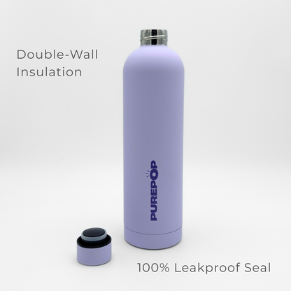A Core Series Plus | Pastel Lilac water bottle with PUREPOP branding is displayed upright, with its cap set beside it. The double-walled stainless steel insulated flask features text reading "Double-Wall Insulation" and "100% Leakproof Seal.