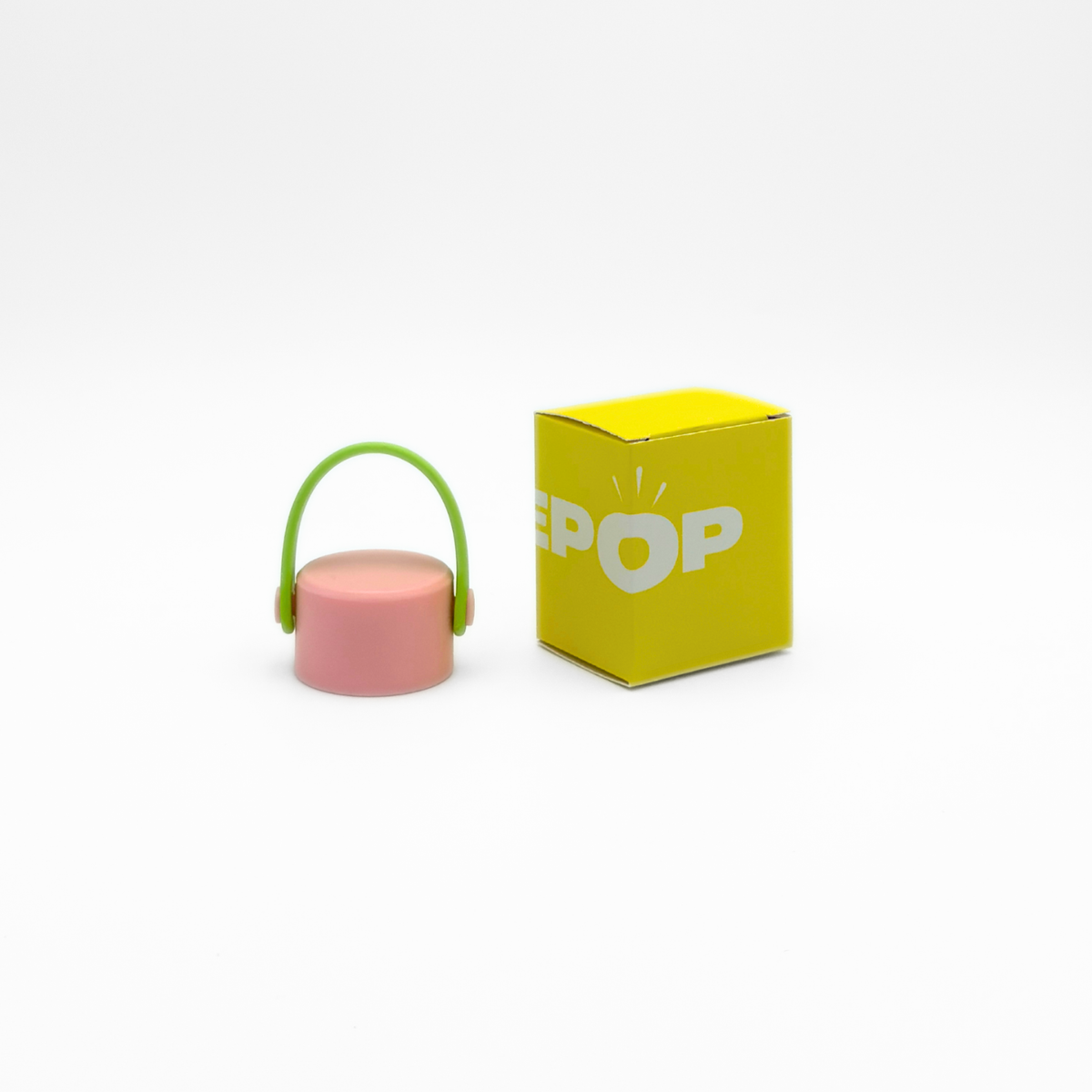 A small pink and lime object, identified as the Core Series Carry Lid with its signature leakproof seal, sits next to a yellow box labeled PUREPOP on a white background.