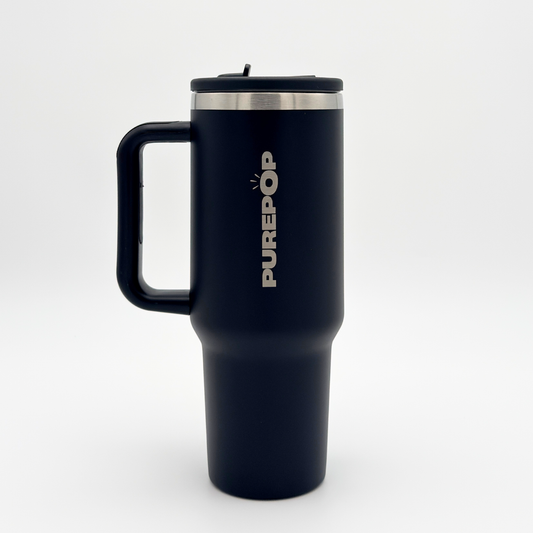 The PurePop™ Carry Series | Onyx Black is a tall, matte black insulated travel mug with a large handle and stainless steel rim, featuring PUREPOP printed vertically in white on the side, shown against a plain white background.