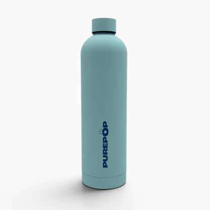 A tall, ice blue double-walled stainless steel bottle from the Core Series Plus collection with a matching cap. The word PUREPOP is printed vertically in dark blue letters on the front. The background is plain white.