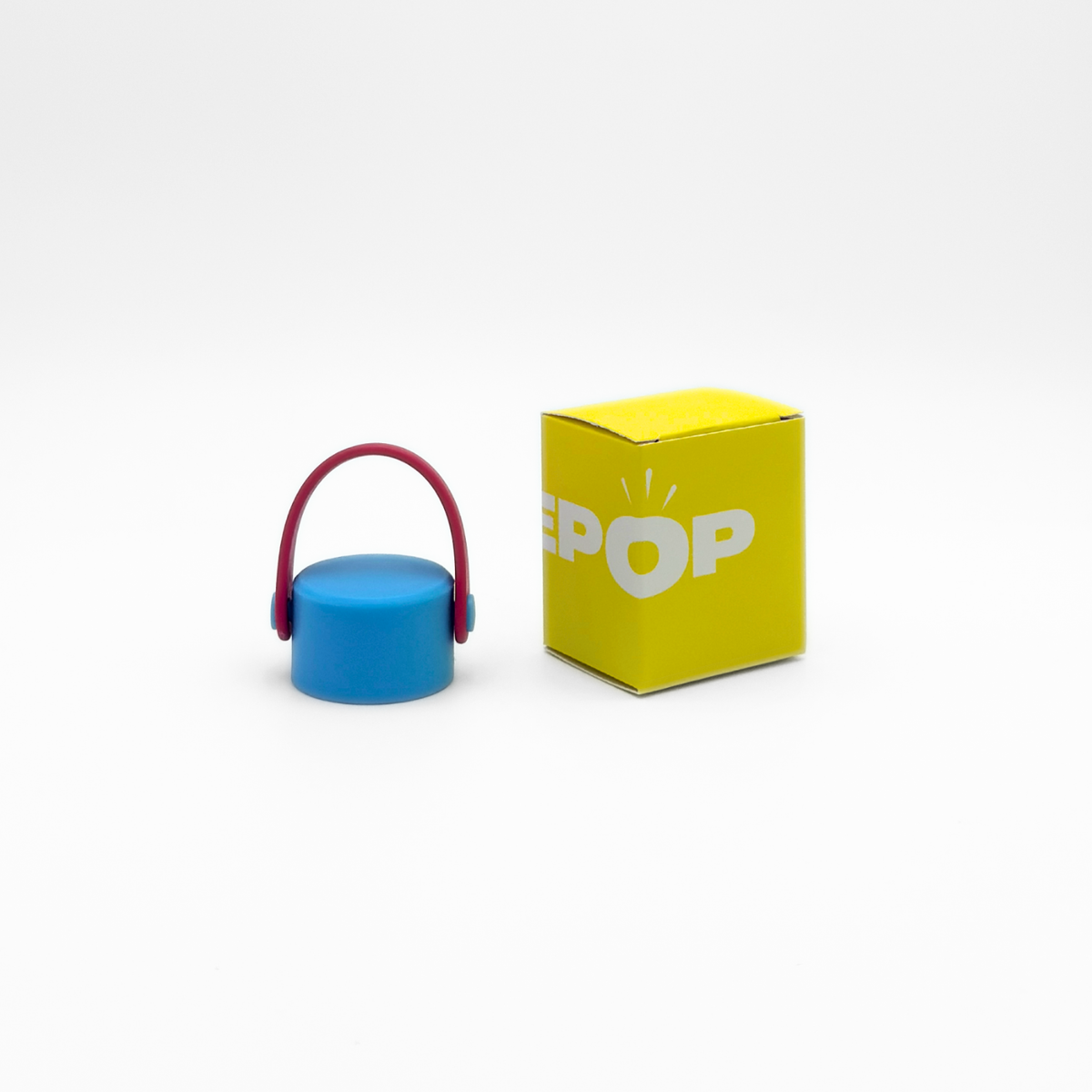 A Core Series | Carry Lid | Crimson & Blue container sits next to a yellow box with white text and a light bulb design on a plain white background.
