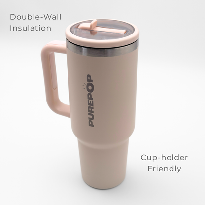 The PurePop™ Carry Series | Rose Quartz is a light pink insulated travel tumbler with a handle and clear lid, featuring double-wall insulation and a cup-holder friendly design—perfect for stylish hydration on the go.