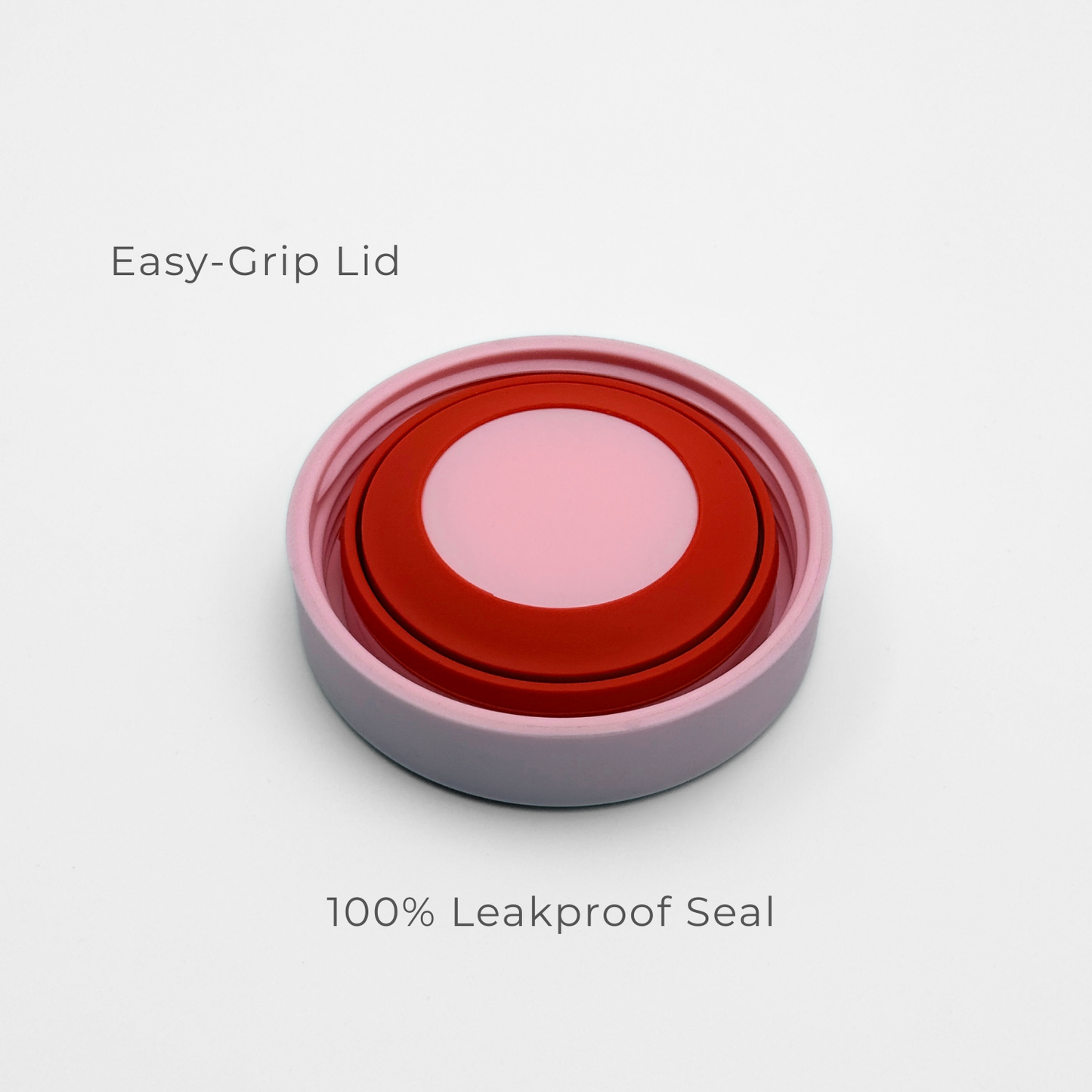 A close-up of Purepop’s Food Flask | Pastel Pink shows its round, red and pink easy-grip lid with a white outer rim on a white background. Text above reads "Easy-Grip Lid" and below reads "100% Leakproof Seal.