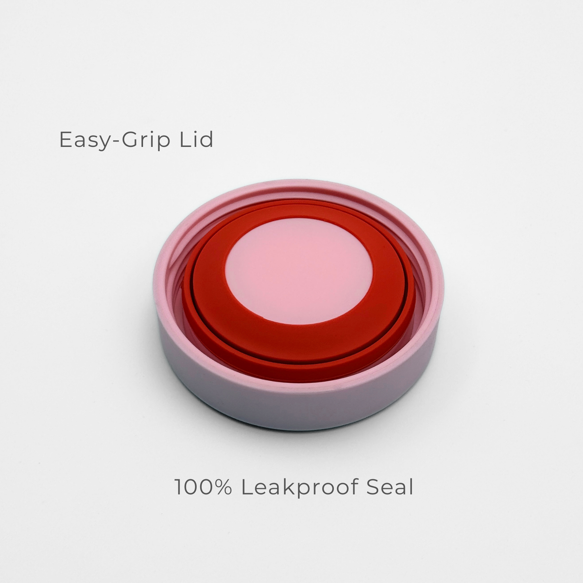 A close-up of Purepop’s Food Flask | Pastel Pink shows its round, red and pink easy-grip lid with a white outer rim on a white background. Text above reads "Easy-Grip Lid" and below reads "100% Leakproof Seal.