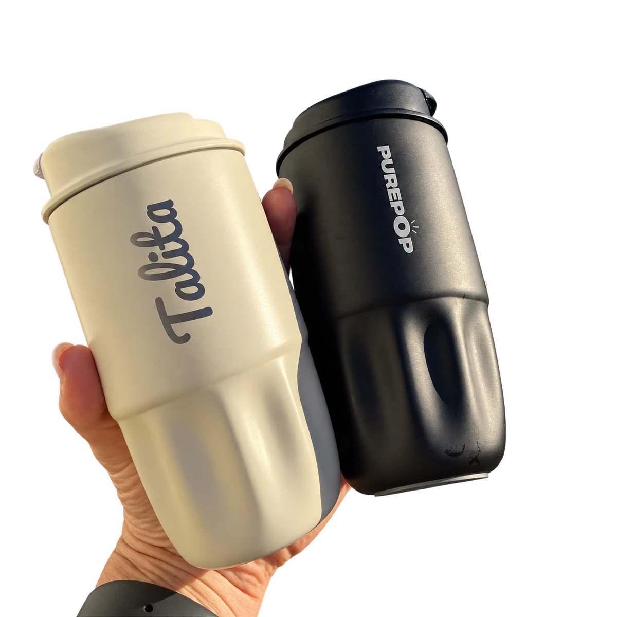 A hand holding an Ivory PurePop flask engraved with Talita beside an Onyx Black PurePop flask.