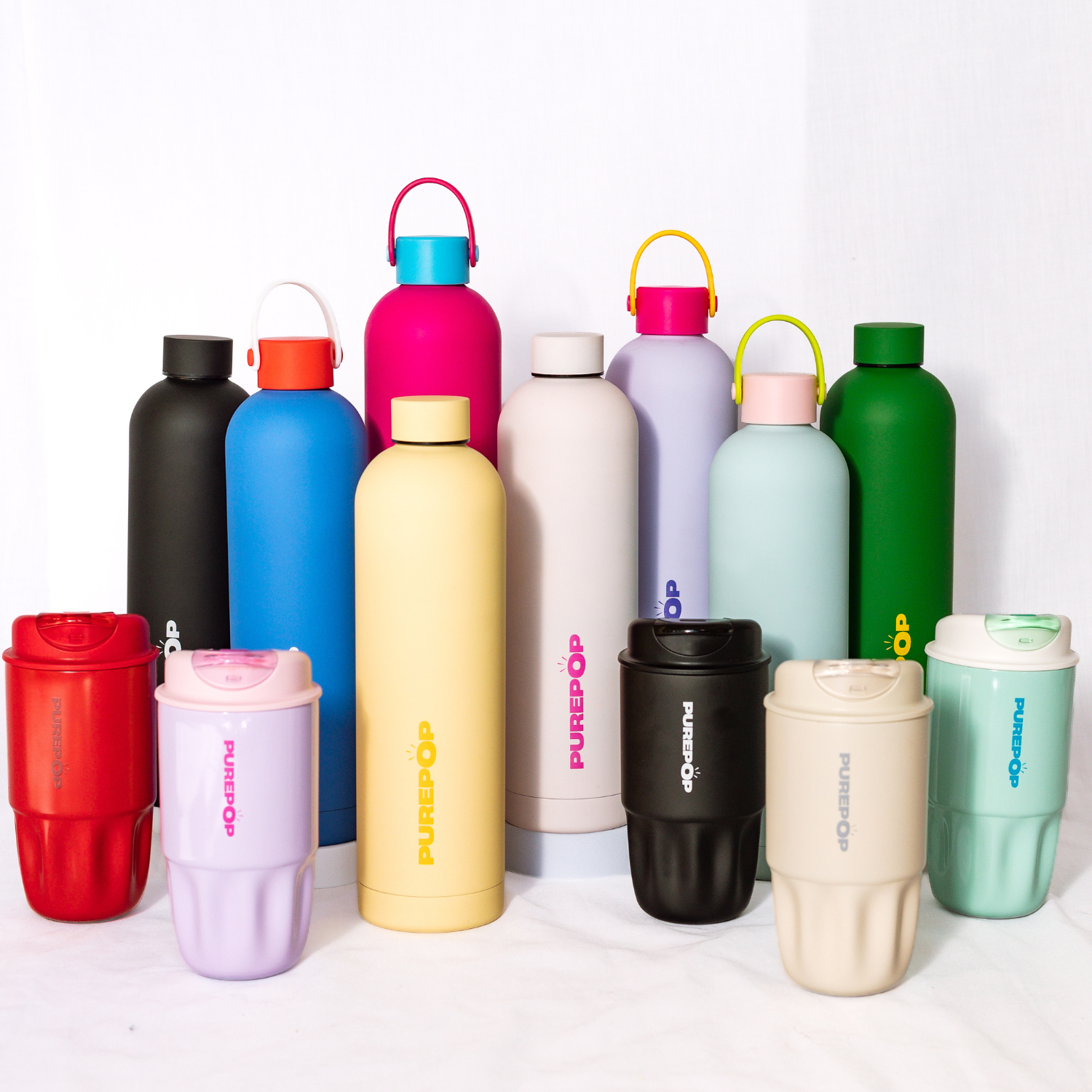 A group of colorful reusable water bottles and cups, each with the PUREPOP logo, arranged in rows on a white background.